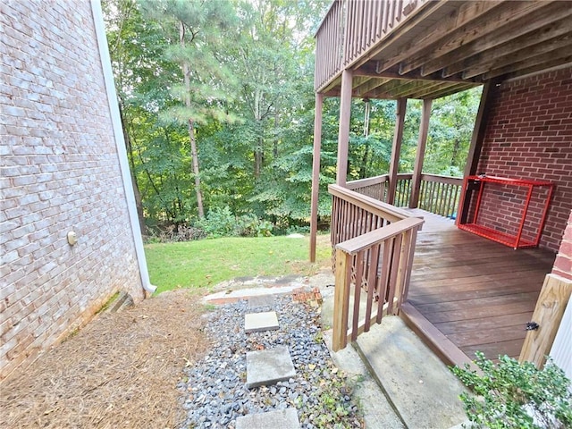 wooden terrace featuring a yard