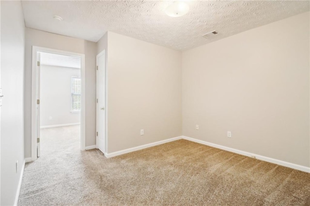 carpeted spare room featuring a notable chandelier