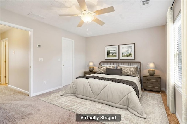 unfurnished room with a textured ceiling, carpet floors, and ceiling fan