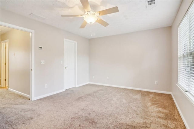 unfurnished bedroom with ceiling fan, light carpet, and a closet