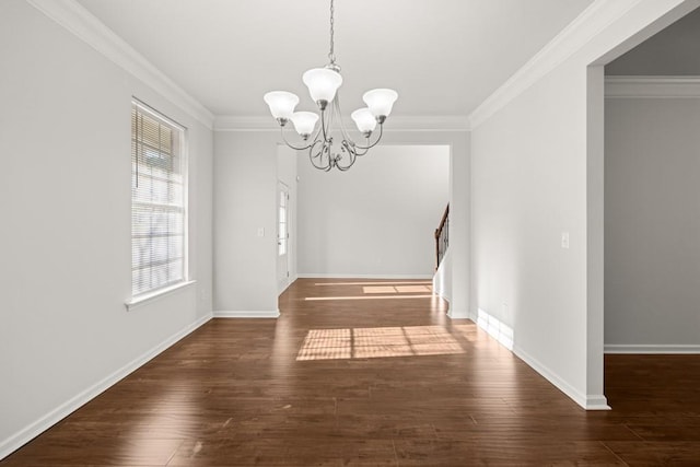 unfurnished dining area with a notable chandelier, crown molding, and stairs