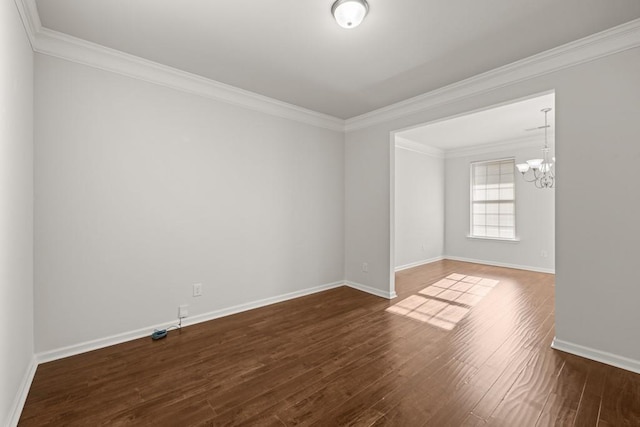 unfurnished room featuring a notable chandelier, ornamental molding, baseboards, and dark wood-style flooring