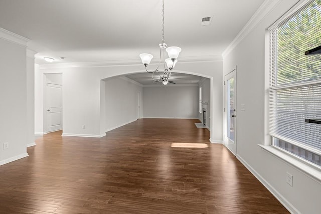 interior space with wood finished floors, visible vents, baseboards, an inviting chandelier, and arched walkways