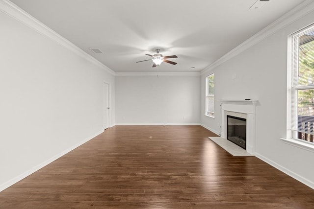 unfurnished living room featuring visible vents, crown molding, baseboards, a fireplace, and dark wood-style flooring