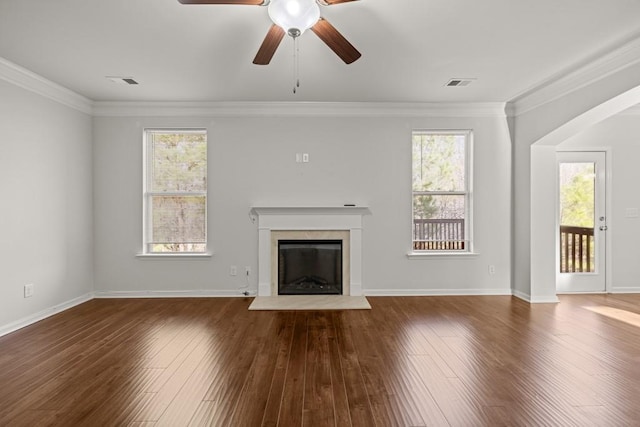 unfurnished living room with visible vents, wood finished floors, and ornamental molding