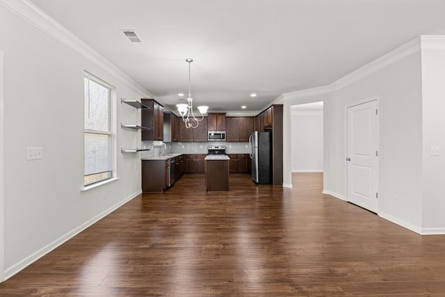 kitchen with visible vents, a kitchen island, dark brown cabinetry, appliances with stainless steel finishes, and an inviting chandelier