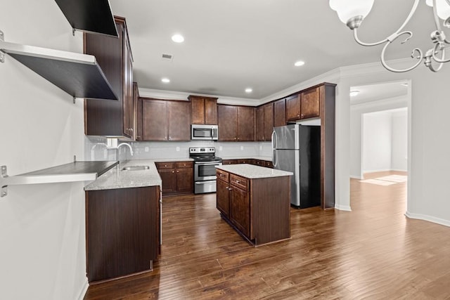 kitchen with open shelves, a kitchen island, appliances with stainless steel finishes, and dark wood-style floors