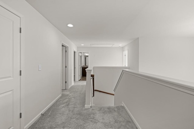 corridor featuring an upstairs landing, recessed lighting, light colored carpet, and baseboards