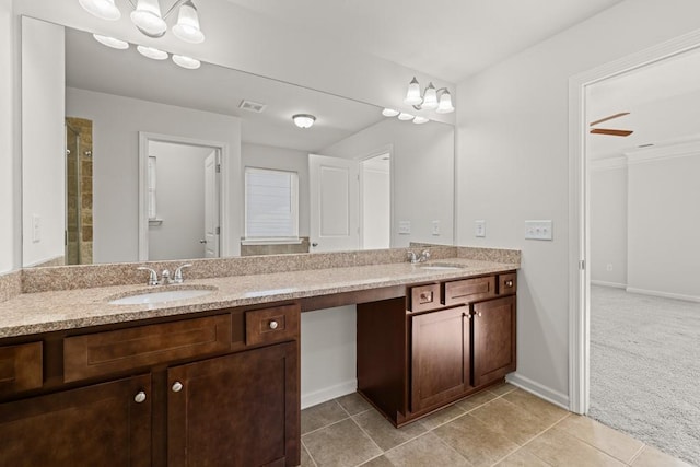 bathroom with tile patterned flooring, double vanity, visible vents, and a sink