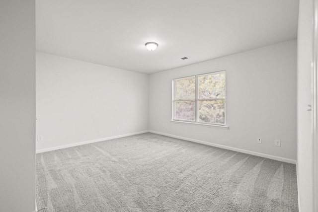 unfurnished room featuring visible vents, baseboards, and carpet