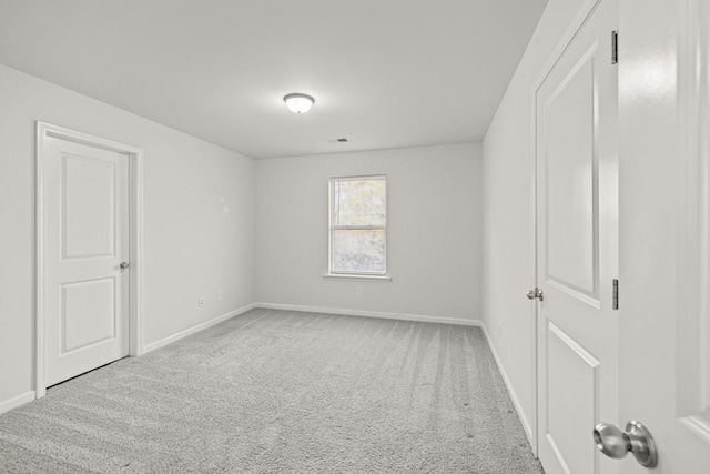 carpeted spare room with baseboards