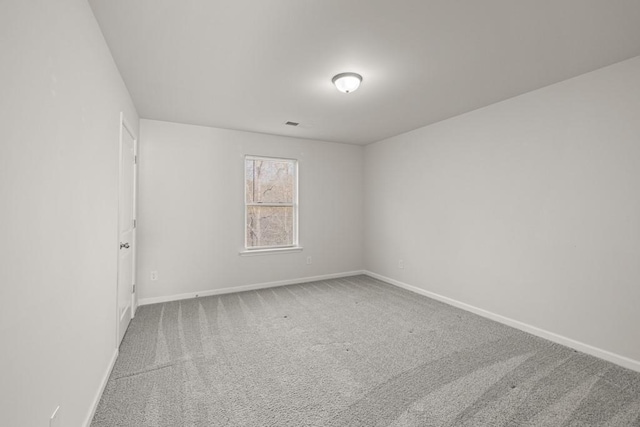 empty room with baseboards and carpet floors