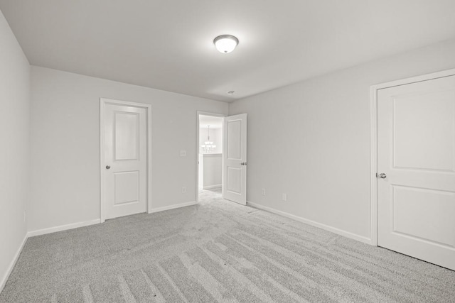 unfurnished bedroom featuring carpet and baseboards