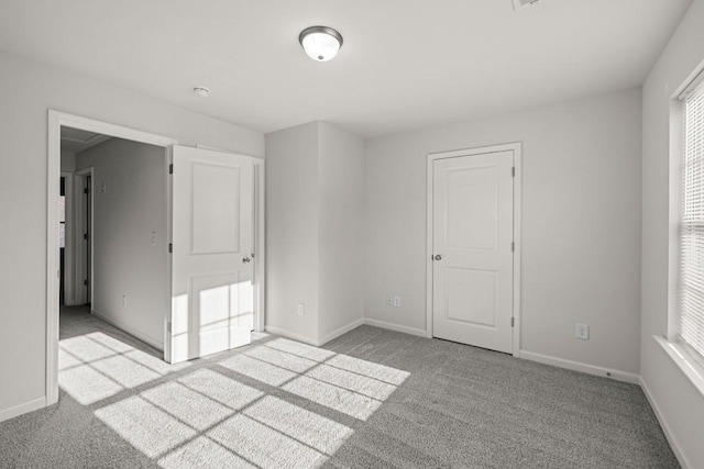 unfurnished bedroom featuring baseboards and carpet floors