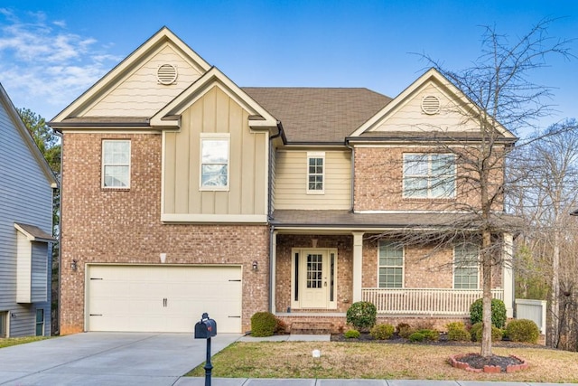 view of front of house featuring brick siding, board and batten siding, covered porch, a garage, and driveway