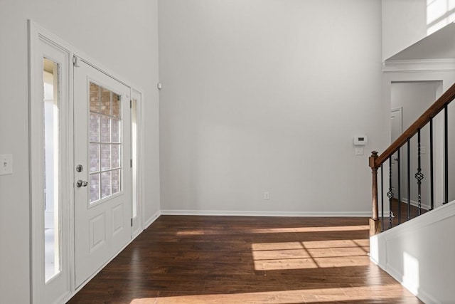 foyer featuring stairs, baseboards, and hardwood / wood-style flooring