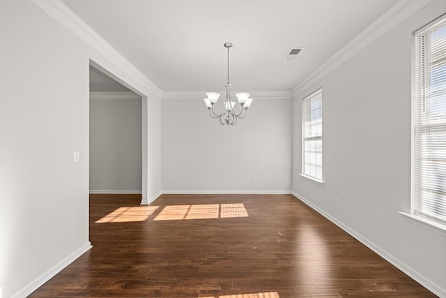 unfurnished dining area with an inviting chandelier, ornamental molding, and hardwood / wood-style flooring