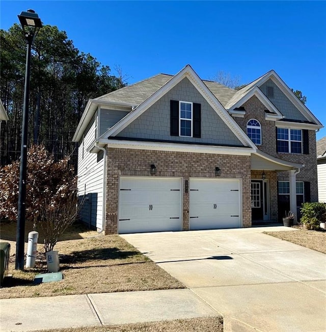 view of front of home with brick siding, driveway, and a garage