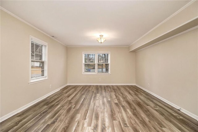 empty room featuring dark hardwood / wood-style flooring and ornamental molding