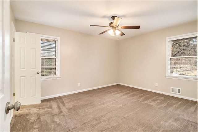 empty room with carpet floors and ceiling fan