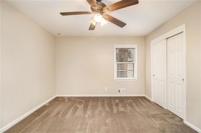 unfurnished bedroom with ceiling fan, carpet floors, and a closet