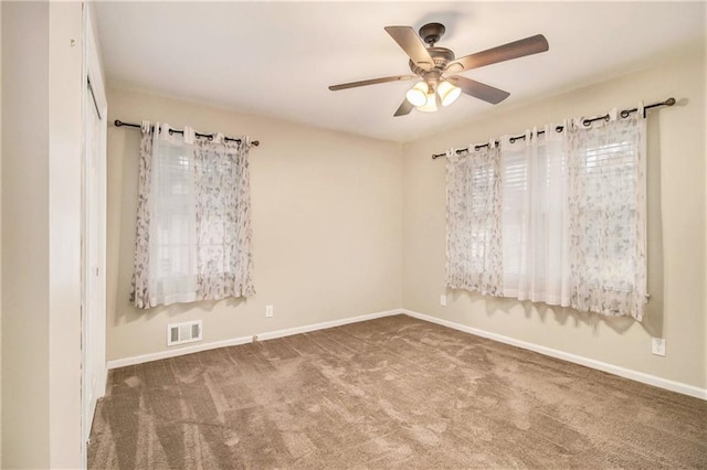 carpeted empty room with ceiling fan