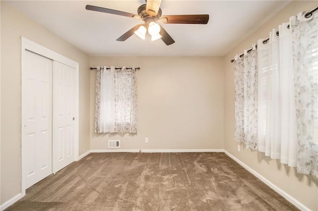 unfurnished bedroom with carpet floors, a closet, and ceiling fan