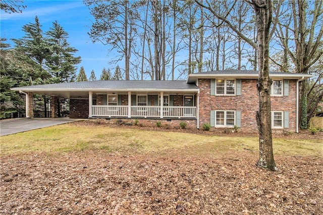 split level home with a front lawn, a carport, and a porch