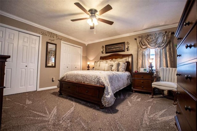 carpeted bedroom with crown molding, a textured ceiling, two closets, and ceiling fan