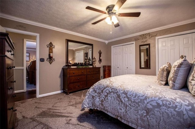 bedroom with crown molding, a textured ceiling, ceiling fan, and multiple closets