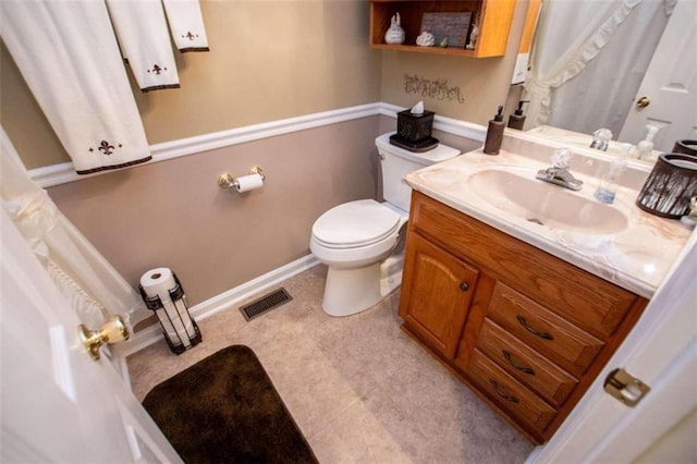 bathroom featuring vanity, toilet, and tile floors