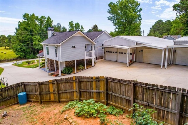 rear view of property featuring a garage