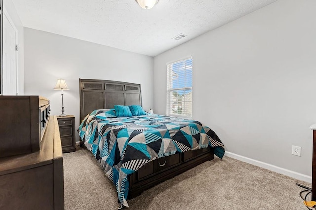 carpeted bedroom with a textured ceiling