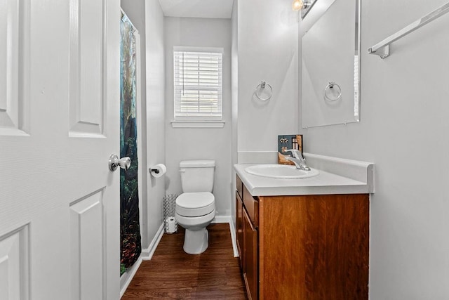 bathroom featuring vanity, hardwood / wood-style floors, and toilet