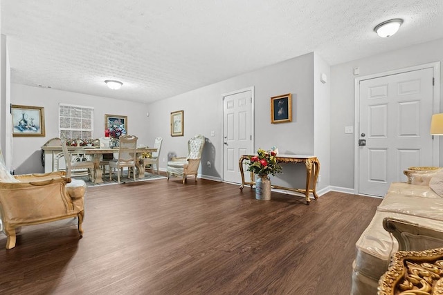 living room with dark hardwood / wood-style flooring and a textured ceiling