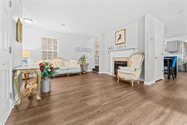 sitting room with dark hardwood / wood-style floors and a textured ceiling