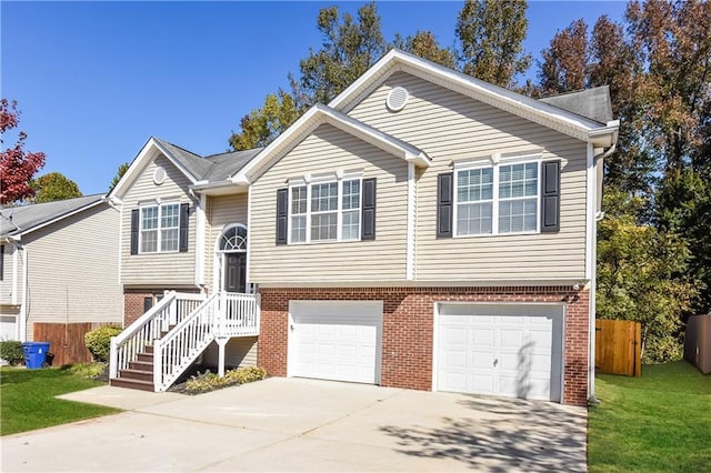 raised ranch with a front lawn and a garage