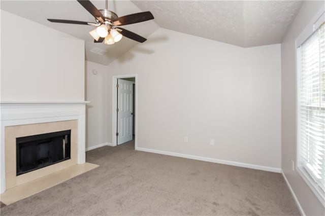 unfurnished living room featuring a textured ceiling, light carpet, ceiling fan, and vaulted ceiling