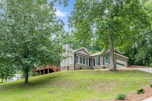 3329 Walt Stephens Rd, Stockbridge, GA 30281 - view of front of property featuring a chimney, an attached garage, driveway, a front yard, and brick siding