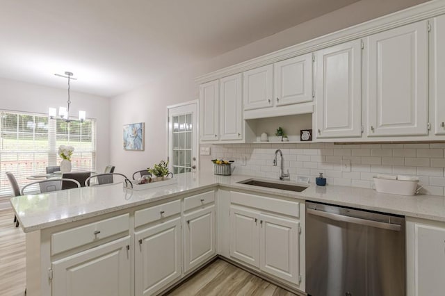 3329 Walt Stephens Rd, Stockbridge, GA 30281 - kitchen featuring stainless steel dishwasher, a peninsula, a chandelier, and tasteful backsplash