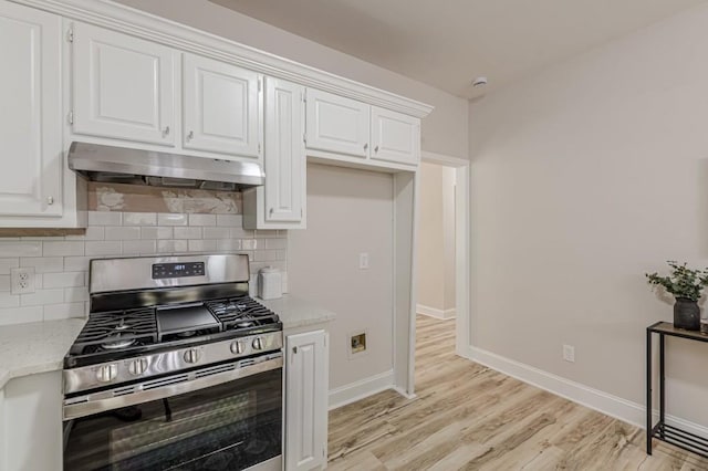 3329 Walt Stephens Rd, Stockbridge, GA 30281 - kitchen with stainless steel range with gas stovetop, range hood, light wood-style flooring, and backsplash