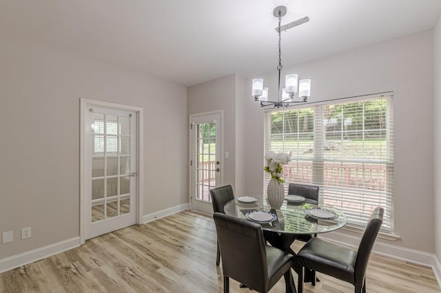 3329 Walt Stephens Rd, Stockbridge, GA 30281 - dining space featuring a chandelier, plenty of natural light, and light wood finished floors