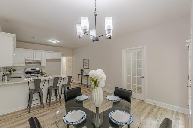 3329 Walt Stephens Rd, Stockbridge, GA 30281 - dining area with a chandelier and light wood finished floors