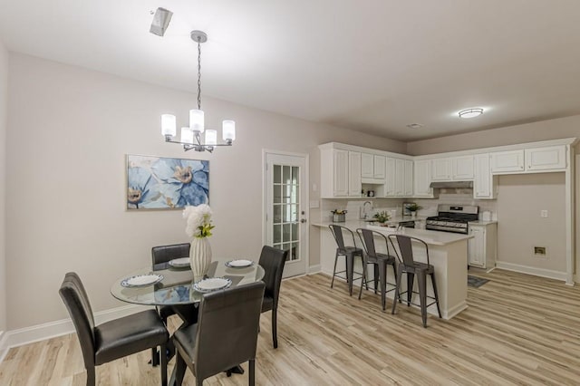 3329 Walt Stephens Rd, Stockbridge, GA 30281 - dining room featuring light wood-type flooring and a chandelier
