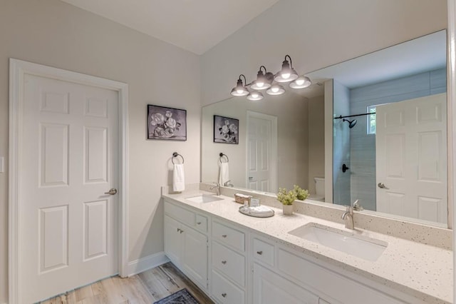 3329 Walt Stephens Rd, Stockbridge, GA 30281 - bathroom with a tile shower, double vanity, and wood finished floors