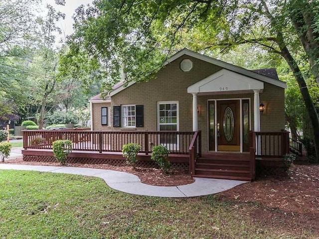 view of front of property with a front lawn and a wooden deck