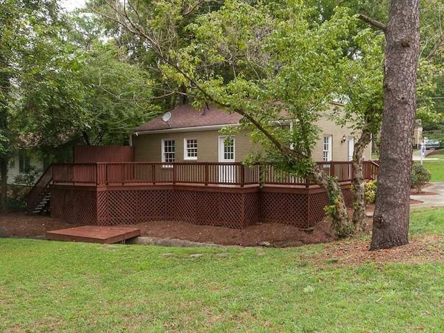 view of side of property featuring a yard and a wooden deck