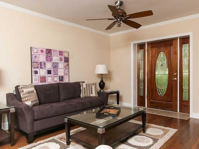 living room featuring ornamental molding, wood-type flooring, and ceiling fan