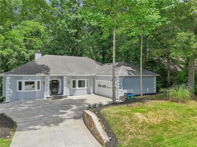 ranch-style house featuring a garage and a front yard