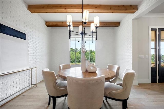 dining room with brick wall, a chandelier, wood finished floors, and beamed ceiling